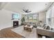 Living room with a fireplace, ceiling fan, and lots of natural light at 433 Village Bend Dr, Fuquay Varina, NC 27526