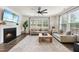 Bright living room features a fireplace, ceiling fan, hardwood floors, and large windows for natural light at 433 Village Bend Dr, Fuquay Varina, NC 27526