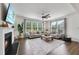 This is a cozy living room with a fireplace, comfortable couches, natural lighting, and stylish decor at 433 Village Bend Dr, Fuquay Varina, NC 27526