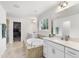 Spacious main bathroom features a soaking tub, double vanities, tile floors, and walk-in closet access at 433 Village Bend Dr, Fuquay Varina, NC 27526