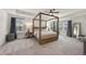 This spacious main bedroom features a tray ceiling, four poster bed and lots of natural light at 433 Village Bend Dr, Fuquay Varina, NC 27526