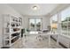 Bright home office featuring two windows, a white desk, a bookshelf, and neutral decor at 433 Village Bend Dr, Fuquay Varina, NC 27526