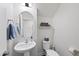 Charming powder room with pedestal sink, modern fixtures, and a decorative mirror and decor at 433 Village Bend Dr, Fuquay Varina, NC 27526