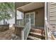 Exterior view of a back porch featuring double doors, brick foundation, and wooden stairs at 4825 Windbreak Ln, Raleigh, NC 27616