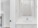Bright bathroom featuring a white vanity and a large mirror, offering a clean and modern feel at 4825 Windbreak Ln, Raleigh, NC 27616