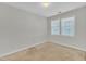 Cozy bedroom with neutral carpeting, white walls, and natural light from windows for a tranquil retreat at 4825 Windbreak Ln, Raleigh, NC 27616