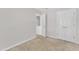 Comfortable bedroom with neutral carpeting, a closet, white walls, and an adjacent bathroom, offering practicality at 4825 Windbreak Ln, Raleigh, NC 27616