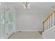 Bright, naturally lit dining area with french doors and chandelier lighting fixture conveniently located near the staircase at 4825 Windbreak Ln, Raleigh, NC 27616