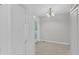 Bright dining area adjacent to the kitchen, featuring a white refrigerator and stylish chandelier lighting fixture at 4825 Windbreak Ln, Raleigh, NC 27616