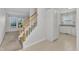 Inviting foyer features a staircase and transitions into an eat-in kitchen with white cabinetry and lots of natural light at 4825 Windbreak Ln, Raleigh, NC 27616
