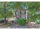 Charming two-story home with a well-maintained front yard and a classic facade, showcasing its inviting curb appeal at 4825 Windbreak Ln, Raleigh, NC 27616