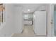A bright kitchen, featuring white appliances and cabinets, transitions seamlessly to the side entrance of the home at 4825 Windbreak Ln, Raleigh, NC 27616