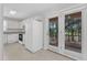 Well-lit kitchen with white appliances, ample cabinet space, and a view to the outdoors through sliding glass doors at 4825 Windbreak Ln, Raleigh, NC 27616