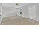 Bright living room with neutral carpet features a door, ceiling fan and large window bringing in natural light at 4825 Windbreak Ln, Raleigh, NC 27616