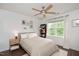 Bright bedroom features a ceiling fan, large window, and neutral decor at 4826 Sir Duncan Way, Raleigh, NC 27612
