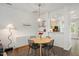 Bright dining area with hardwood floors, modern lighting, and a view into the kitchen at 4826 Sir Duncan Way, Raleigh, NC 27612