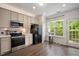 Modern kitchen with stainless steel appliances, white cabinets, and plenty of counter space at 4826 Sir Duncan Way, Raleigh, NC 27612
