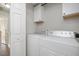 Functional laundry room with a washer and dryer and storage cabinets at 4826 Sir Duncan Way, Raleigh, NC 27612