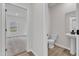 Well-lit bathroom featuring a pedestal sink, toilet, and modern flooring at 503 Benton Dr, Oxford, NC 27565