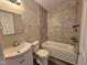 Updated bathroom featuring tiled shower and bathtub combo, stylish fixtures, and new toilet at 511 Commonwealth St, Durham, NC 27703