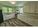 The spacious kitchen features white cabinetry, granite countertops, and modern appliances at 511 Commonwealth St, Durham, NC 27703