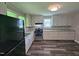 A newly renovated kitchen with stainless steel appliances, granite countertops, and ample cabinet space at 511 Commonwealth St, Durham, NC 27703