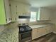 Well-equipped kitchen showcasing granite countertops, stainless steel appliances, and ample storage at 511 Commonwealth St, Durham, NC 27703