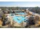 Overhead shot of a large community pool area with slides, a clubhouse, and lounge spots at 518 Emerald Downs Rd, Cary, NC 27519