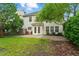 A spacious backyard featuring a patio, green grass, a mature shade trees and an outdoor seating area at 518 Emerald Downs Rd, Cary, NC 27519