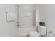 Clean bathroom featuring a white shower-tub, white walls, and a toilet with foliage at 518 Emerald Downs Rd, Cary, NC 27519
