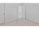 A bedroom with neutral carpet and an open door at 518 Emerald Downs Rd, Cary, NC 27519