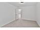 A bedroom with neutral carpet and an open door at 518 Emerald Downs Rd, Cary, NC 27519
