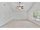 Large bedroom with vaulted ceiling, ceiling fan, and neutral carpet at 518 Emerald Downs Rd, Cary, NC 27519