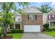 Charming brick home with a two-car garage and a well-manicured front yard at 518 Emerald Downs Rd, Cary, NC 27519