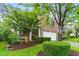 Charming brick home with a two-car garage and a well-manicured front yard at 518 Emerald Downs Rd, Cary, NC 27519