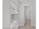 A hallway leading to a closet, illuminated by natural light through window at 518 Emerald Downs Rd, Cary, NC 27519