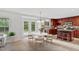 Eat-in kitchen with stainless steel appliances, tile floors, wooden cabinets, island seating, and a backyard view at 518 Emerald Downs Rd, Cary, NC 27519