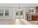 Sunlit eat-in kitchen with tile floors, backyard views from the french doors, and stainless-steel appliances at 518 Emerald Downs Rd, Cary, NC 27519