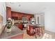 Kitchen featuring stainless steel appliances, an island with barstool seating, and warm wooden cabinetry at 518 Emerald Downs Rd, Cary, NC 27519