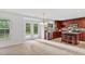 Eat-in kitchen with stainless steel appliances, tile floors, wooden cabinets, island seating, and backyard access at 518 Emerald Downs Rd, Cary, NC 27519