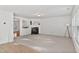 Bright living room with plush carpet, fireplace, and abundant natural light creates a cozy atmosphere at 518 Emerald Downs Rd, Cary, NC 27519