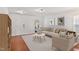 Bright living room featuring neutral decor, hardwood floors, and ample natural light at 518 Emerald Downs Rd, Cary, NC 27519