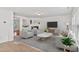 Bright living room with plush carpet, fireplace, modern furniture, and abundant natural light creates a cozy atmosphere at 518 Emerald Downs Rd, Cary, NC 27519