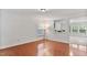 Empty living room with hardwood flooring, a window, and an open space to another room at 518 Emerald Downs Rd, Cary, NC 27519
