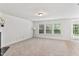 Spacious living room with carpeted floors, a fireplace, and lots of light at 518 Emerald Downs Rd, Cary, NC 27519