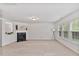 Inviting living room featuring a fireplace, neutral carpet, and large windows for ample natural light at 518 Emerald Downs Rd, Cary, NC 27519