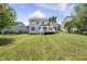 Large, grassy backyard includes a deck and is surrounded by neighboring houses and trees at 5317 Peacenest Dr, Raleigh, NC 27610
