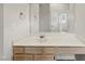 Bathroom with white vanity, large mirror, and plenty of storage below at 5317 Peacenest Dr, Raleigh, NC 27610