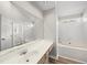 Bathroom with white cabinets, vanity, and bath tub with tile surround at 5317 Peacenest Dr, Raleigh, NC 27610
