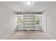 Bedroom featuring built in shelving, carpeted floors, and bright windows at 5317 Peacenest Dr, Raleigh, NC 27610